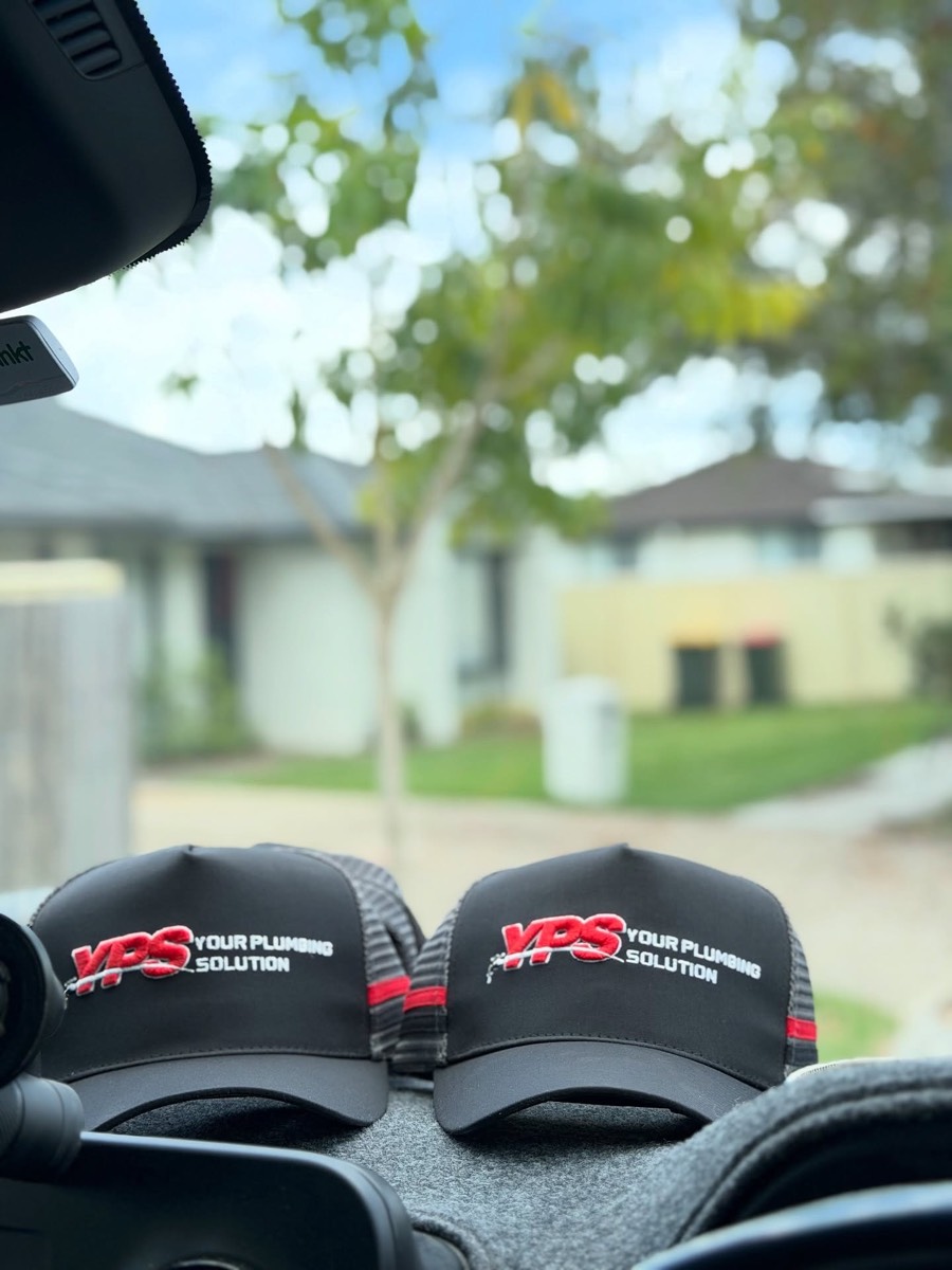 Custom black and red trucker caps for Your Plumbing Solution